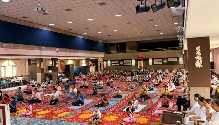 Students, teachers, parents and community members practicing yoga during International Yoga Day celebrations at DAV Gian Prakash Chopra Public School in Faridabad.
